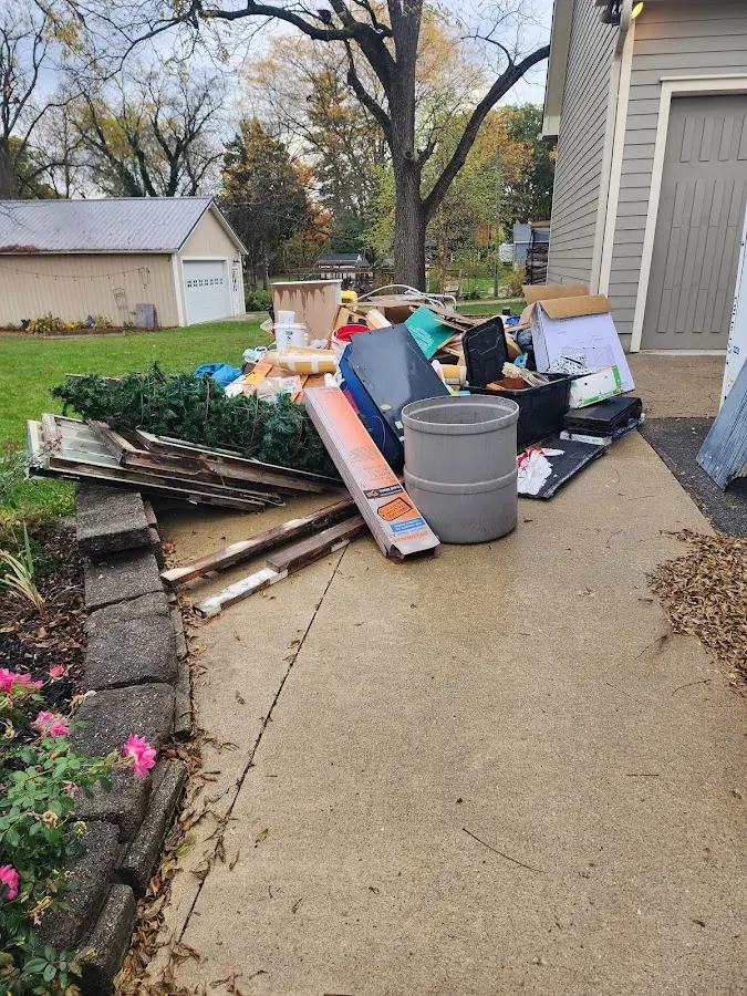 Dumpster being loaded with debris for 10 Yard Dumpster Rental in Chazy